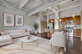 A modern living room with a white sofa and a coffee table.